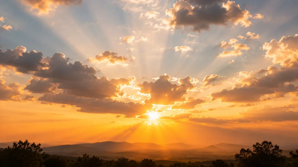 [Imagem: céu iluminado ao entardecer com raios de sol atravessando nuvens suaves]