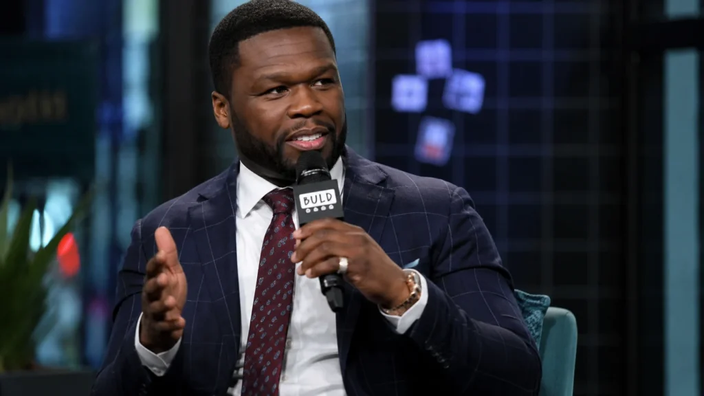 [Imagem: 50 Cent durante uma entrevista, transmitindo confiança e postura de liderança.]